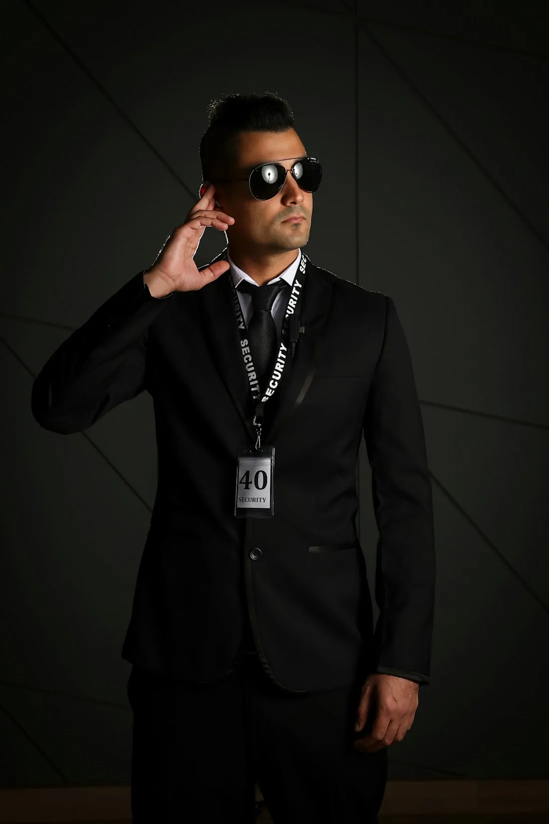 Escolta de traje negro con auricular y gafas oscuras